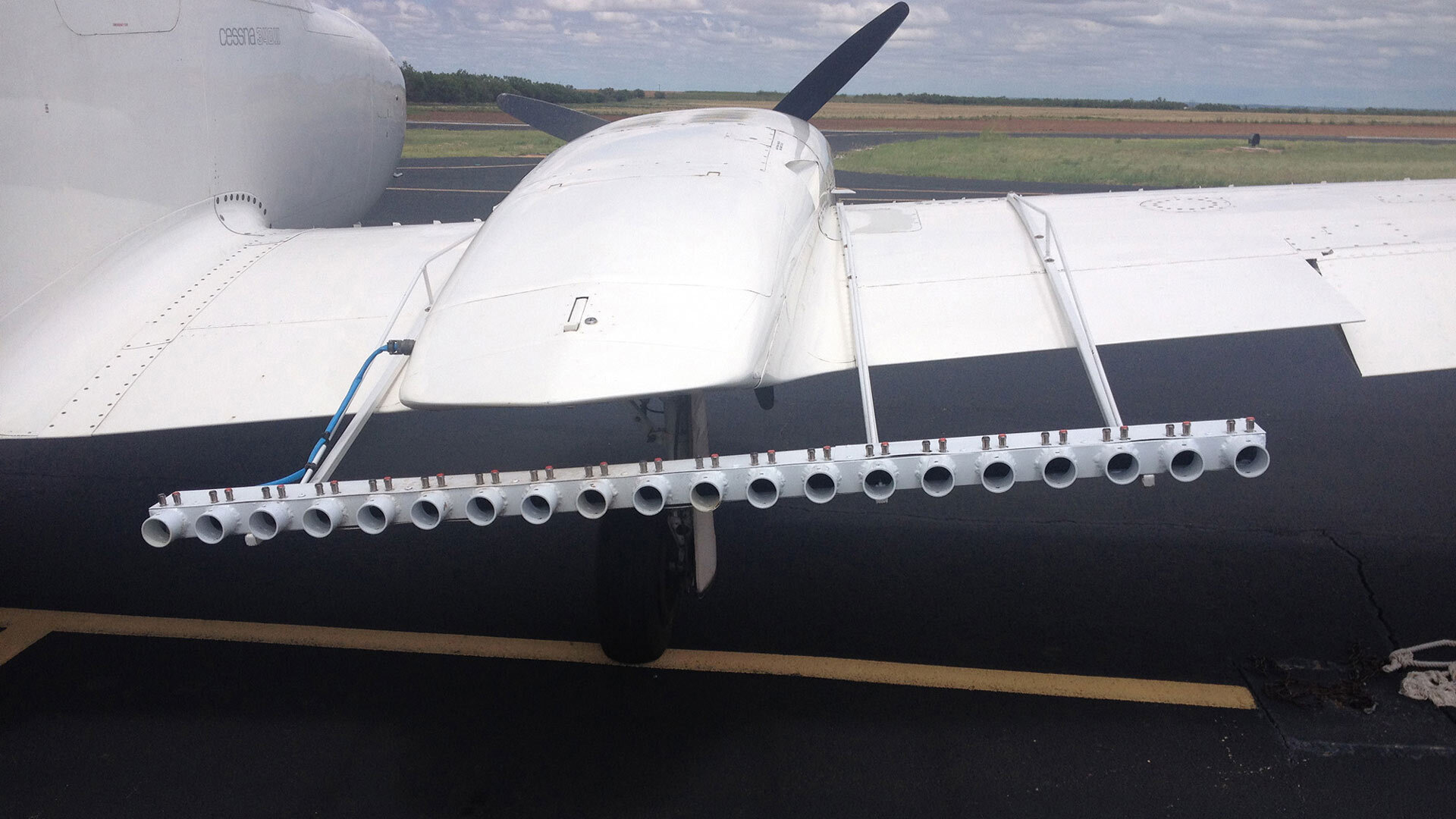 Cloud seeding aircraft dispersing flares over mountain range